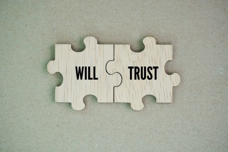 Wooden puzzle pieces labeled Will and Trust fitting together to show how both tools work in a complete estate plan.