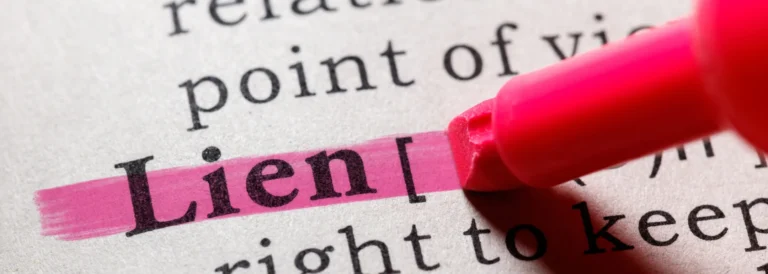 The word “Lien” highlighted in pink on a printed page with a pink marker.