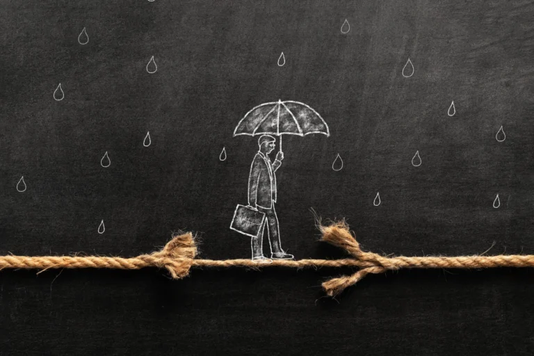 Chalk drawing of a person holding an umbrella and walking on a frayed rope in the rain, symbolizing financial or legal risk.