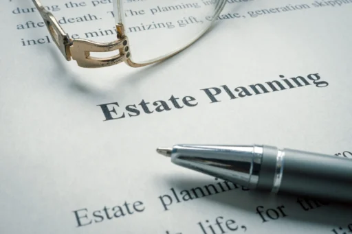 Close-up of an estate planning document with glasses and a pen, illustrating how wills fit into a complete estate plan.