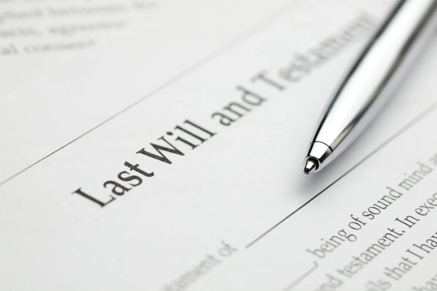 Close-up of a Last Will and Testament document with a silver pen resting on it