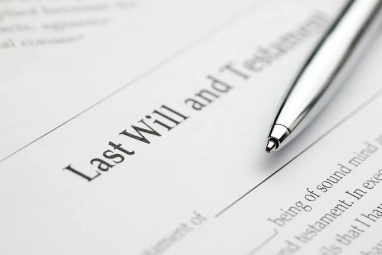 Close-up of a Last Will and Testament document with a silver pen resting on it