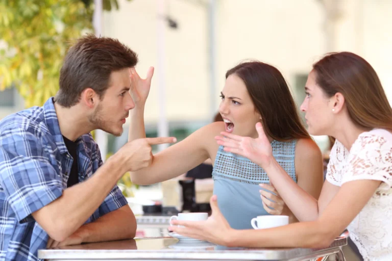 Siblings arguing heatedly at a café highlighting common trust disputes and inheritance conflicts.